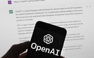 FILE - The OpenAI logo is seen on a mobile phone in front of a computer screen which displays output from ChatGPT, Tuesday, March 21, 2023, in Boston. White House officials concerned about AI chatbots' potential for societal harm and the Silicon Valley powerhouses rushing them to market are heavily invested in a three-day competition ending Sunday, Aug. 13, at the DefCon hacker convention in Las Vegas. Some 3,500 competitors have tapped on laptops seeking to expose vulnerabilities in eight leading large-language models representative of technology’s next big thing. (AP Photo/Michael Dwyer)