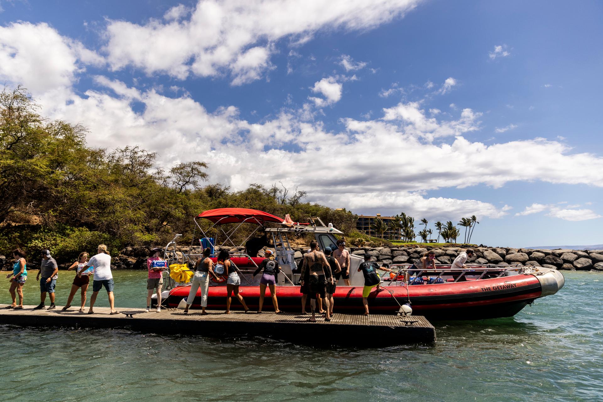 Volunteers load supplies onto a boat headed for West Maui at Kihei Landing, Sunday, August 13, 2023.