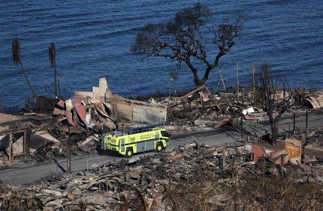 A fire truck drives through a neighborhood destroyed by fire on August 11, 2023, in Lahaina, Hawaii.