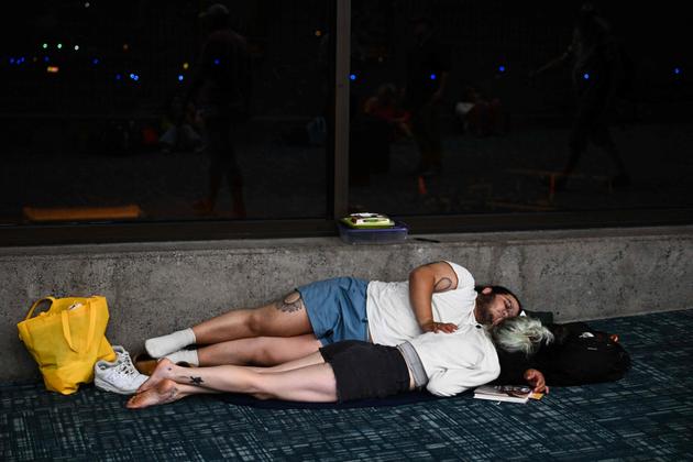 Passengers in the terminal of Kahului airport wait for delayed or canceled flights out of Hawaii, on August 9, 2023.