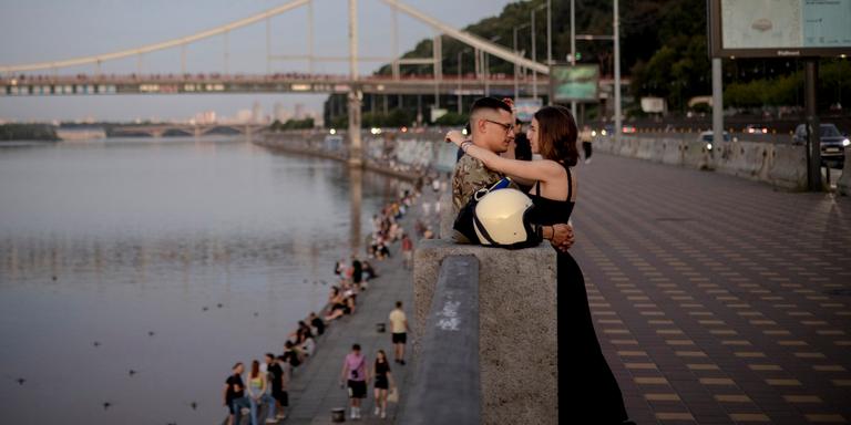 A Ukrainian soldier and his companion embrace on the banks of the Dnieper River, Kiev, Ukraine, August 13, 2023.