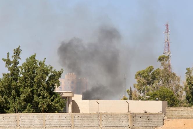 Smoke rises during clashes between rival militias in Tripoli, Libya, Tuesday, Aug. 15, 2023.