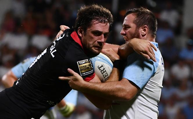 Toulouse's center Pierre-Louis Barassi (L) is tackled by Bayonne's fly-half Camille Lopez during the Top 14 rugby union match between Aviron Bayonnais and Stade Toulousain at the Jean Dauger stadium in Bayonne, on August 18, 2023. 
