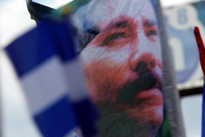 A banner emblazoned with an image of Nicaragua's President Daniel Ortega is waved by a supporter in Managua, Nicaragua, April 30, 2018. 