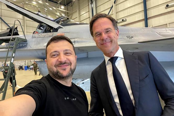 Ukraine's President Volodymyr Zelensky (L) takes a selfie with Dutch Prime Minister Mark Rutte (R) during a visit to the Eindhoven Military Air Base in Eindhoven, August 20, 2023. 
