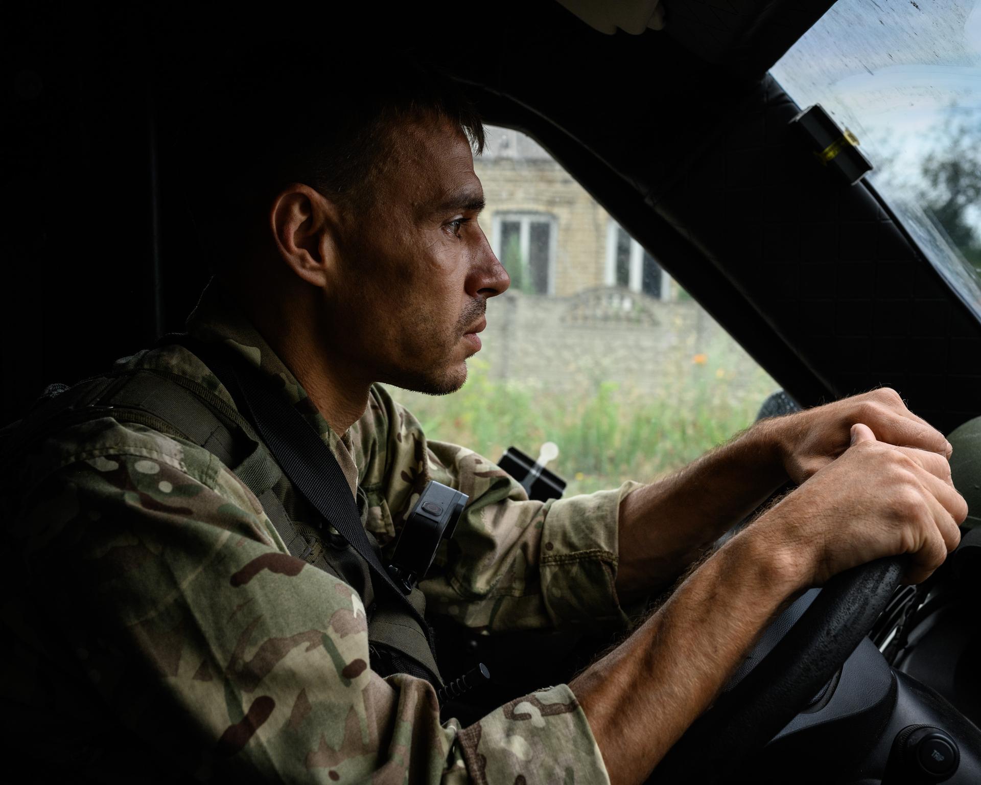 Vassilyi Pipa, 41, drives an old armored van on the road between Kurakhove and Marinka. He is a member of the "White Angels," a unit of the Kurakhove police force that exfiltrates and assists civilians in the front zone. Maksymilyanivka (Ukraine), July 8, 2023.
