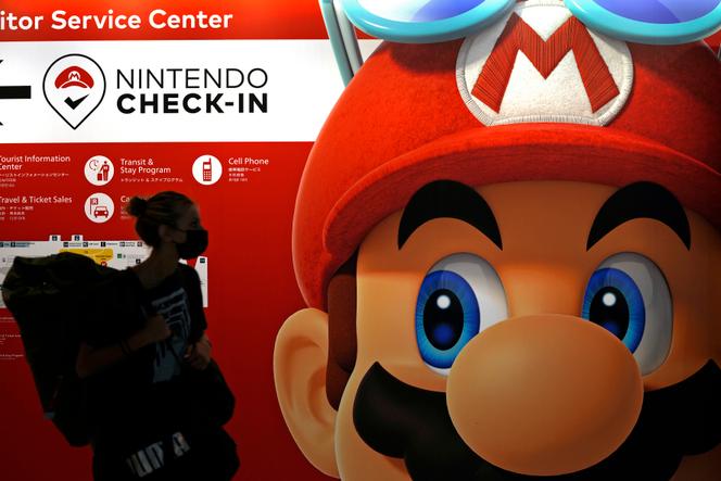 A person passes an ad featuring the Nintendo character Mario at Narita airport in Narita near Tokyo on June 10, 2022. 