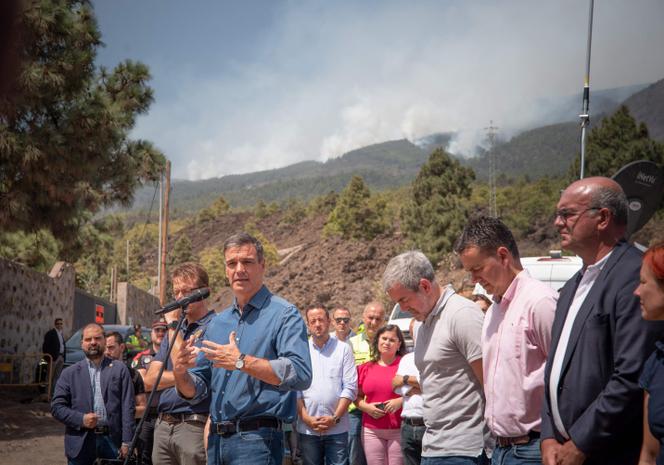 Pedro Sanchez, Spain's outgoing prime minister (at microphone), and the president of the Canary Islands government, Fernando Clavijo (in gray T-shirt ), during a visit to the forward control post for emergency units at Arafo, on the island of Tenerife, August 21, 2023.