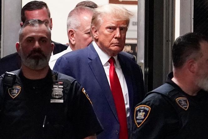 Former President Donald Trump is escorted to a courtroom, April 4, 2023, in New York.