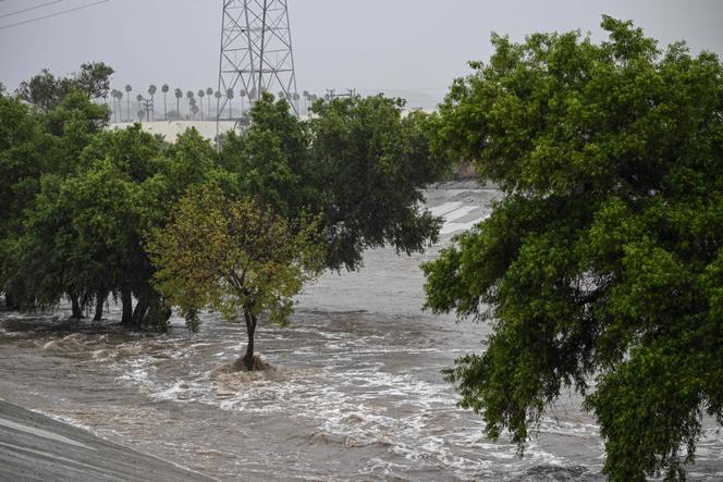 The Los Angeles River swells with rushing water near Griffith Park in Los Angeles, California on August 20, 2023.