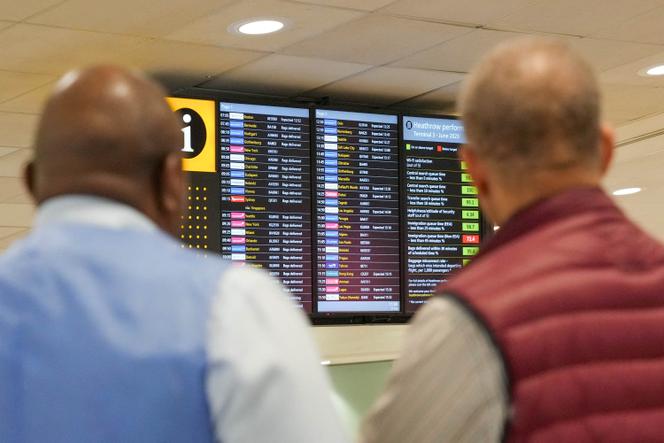 People look at arrivals board in Heathrow Terminal 3 in London, Britain, August 22, 2023. 