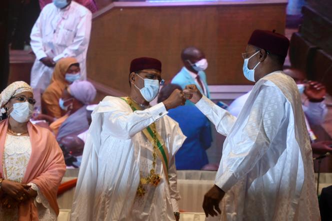 Mohamed Bazoum (center), elected president of Niger, and former president Mahamadou Issoufou (right) at his inauguration at the Niamey International Conference Center, April 2, 2021.