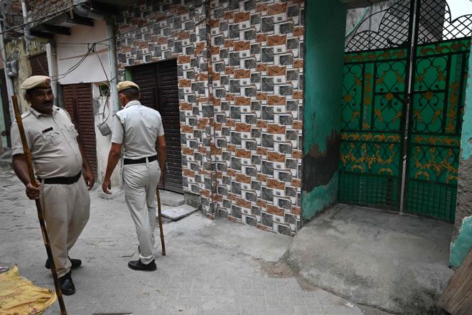 Police officers guard the entrance to a mosque in Gurgaon after anti-Muslim riots in the Indian state of Haryana, August 4, 2023.