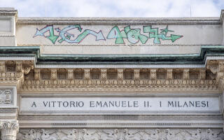 FILE - A graffiti is seen on the facade of the Vittorio Emanuele Arcade in Milan, Italy, Tuesday, Aug. 8, 2023. The director of Florence’s Uffizi Galleries called Wednesday, Aug. 23, 2023 for U.S.-style penalties against vandals who spraypainted graffiti on exterior columns of the Varsari Corridor connecting the famed museum to the Boboli Gardens. Political and cultural leaders condemned the graffiti, the latest in a summer of high-profile acts of vandalism targeting Italian monuments, including the Colosseum in Rome and Milan's landmark Vittorio Emmanuele II Galleria. (Claudio Furlan/LaPresse via AP, File)