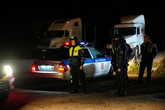 Russian police officers stand guard near the crash site of the private jet carrying Yevgeny Prigozhin on August 24, 2023 in Tver region, Russia.