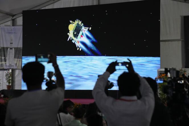 Journalists film the live telecast of spacecraft Chandrayaan-3 landing on the moon at ISRO's Telemetry, Tracking and Command Network facility in Bengaluru, India, Wednesday, August 23, 2023.