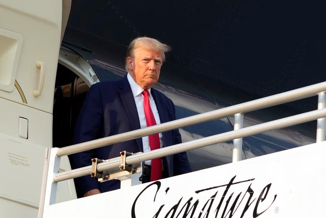 Former President Donald Trump steps off his plane as he arrives at Hartsfield-Jackson Atlanta International Airport, Thursday, Aug. 24, 2023, in Atlanta. 