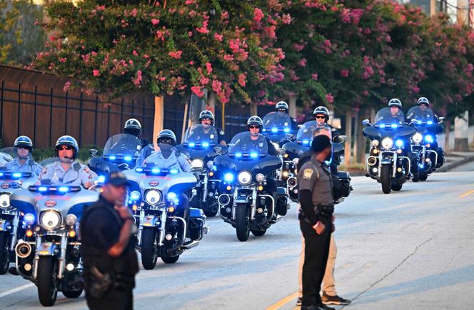 State troopers are seen on motorcycles as former US President and 2024 Presidential hopeful Donald Trump arrives at the Fulton County Jail in Atlanta, Georgia, on August 24, 2023. 