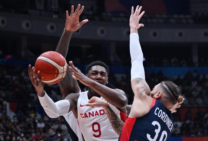 Canada's RJ Barrett (C) and France's Isaia Cordinier (R) vie for the ball during the FIBA Basketball World Cup group H match between France and Canada at Indonesia Arena in Jakarta on August 25, 2023.