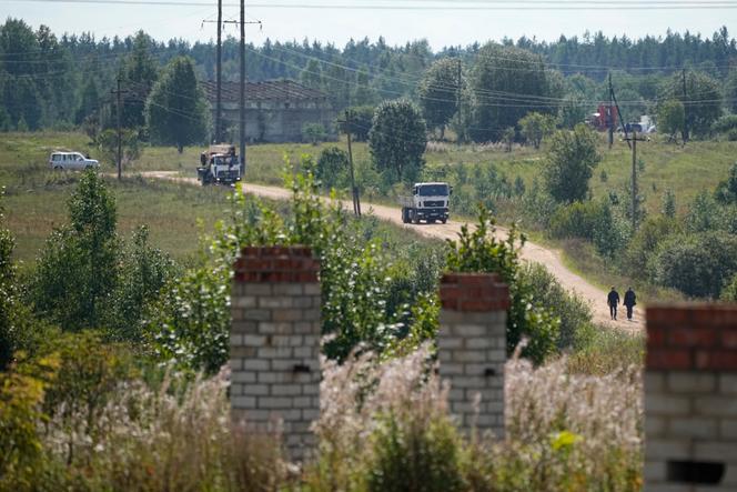 Trucks and a crane leave the site of the private jet crash, near the village of Kuzhenkino, Tver region, Russia, Friday, August 25, 2023.