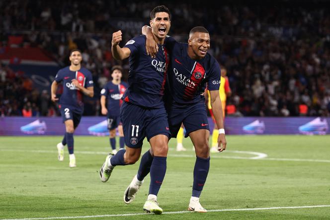 Paris Saint-Germain's Spanish forward #11 Marco Asensio (C) celebrates with Paris Saint-Germain's French forward #07 Kylian Mbappe (R) after scoring Paris Saint-Germain's first goal during the French L1 football match between Paris Saint-Germain (PSG) and RC Lens at the Parc des Princes Stadium in Paris on August 26, 2023.