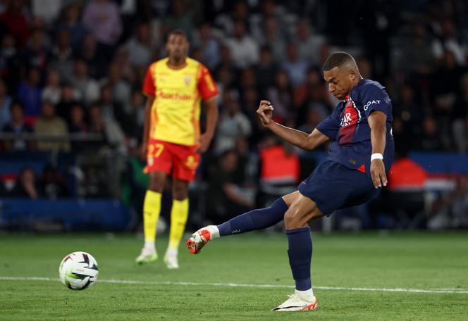 Paris Saint-Germain's French forward #07 Kylian Mbappe shoots to score Paris Saint-Germain's third goal during the French L1 football match between Paris Saint-Germain (PSG) and RC Lens at the Parc des Princes Stadium in Paris on August 26, 2023.