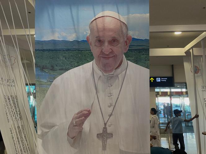 A poster for the upcoming visit of Pope Francis is displayed at the airport in Mongolia's capital of Ulaanbaatar on August 30, 2023. 