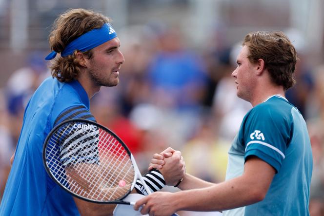 Stefanos Tsitsipas (L) of Greece shakes hands with Dominic Stephan Stricker of Switzerland after being defeated following their Men's Singles second-round match on Day Two of the 2023 US Open at the USTA Billie Jean King National Tennis Center on August 30, 2023 in the Flushing neighborhood of the Queens borough of New York City.