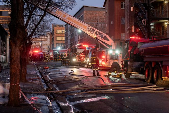 Firefighters work at the scene of a deadly blaze in the early hours of the morning, in Johannesburg, South Africa, on August 31, 2023.