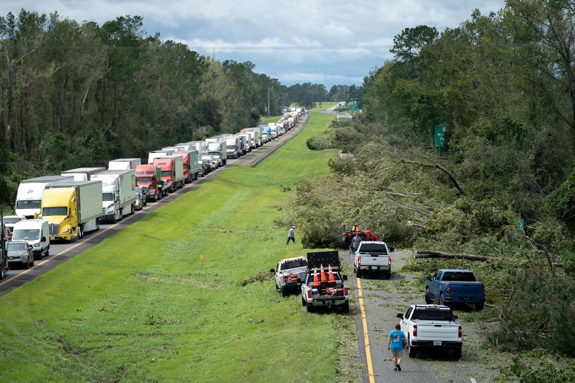 People work to clear I-10 of fallen trees, near Madison, Florida, on August 30, 2023.
