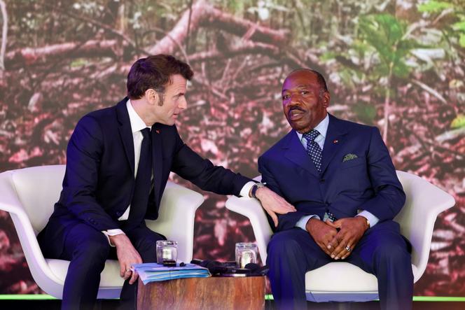 French President Emmanuel Macron speaks with Gabonese President Ali Bongo Ondimba at the One Forest summit at the presidential palace in Libreville on March 2, 2023.