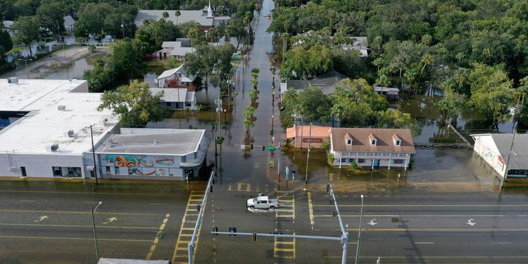 JOE RAEDLE / AFP CRYSTAL RIVER, FLORIDA - AUGUST 30: In an aerial view, a vehicle drives through a flooded street in the downtown area after Hurricane Idalia passed offshore on August 30, 2023 in Crystal River, Florida. Hurricane Idalia hit the Big Bend area on the Gulf Coast of Florida as a Category 3 storm. Joe Raedle/Getty Images/AFP (Photo by JOE RAEDLE / GETTY IMAGES NORTH AMERICA / AFP)