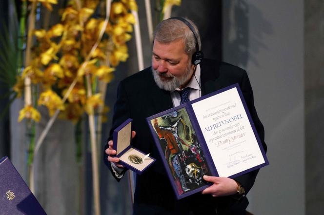 Nobel Peace Prize laureate Dmitry Muratov of Russia poses with the Nobel Peace Prize during the gala award ceremony on December 10, 2021 in Oslo.