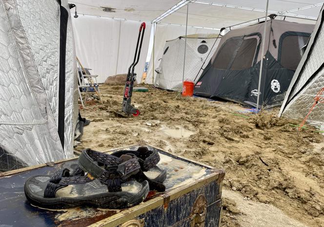 A pair of sandals are seen on a chest in the middle of tents on September 3, 2023.