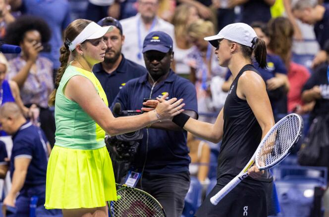 Jelena Ostapenko (left) shakes hands with Iga Swiatek, whom she just beat in the round of 16 at the US Open, in New York on September 3, 2023.
