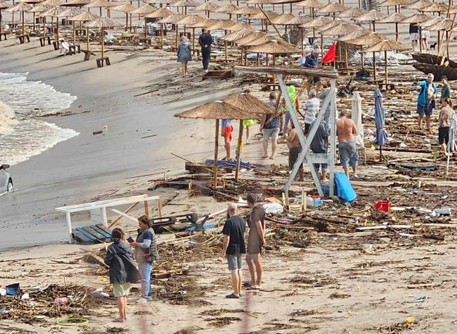People observe the damage on the beach, after a storm, in Arapya, Bulgaria, Tuesday, September 5, 2023.
