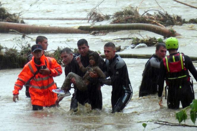 Emergency team members rescue a young girl during floods in a campsite in Kirklareli province, Turkey, Tuesday, September 5, 2023.