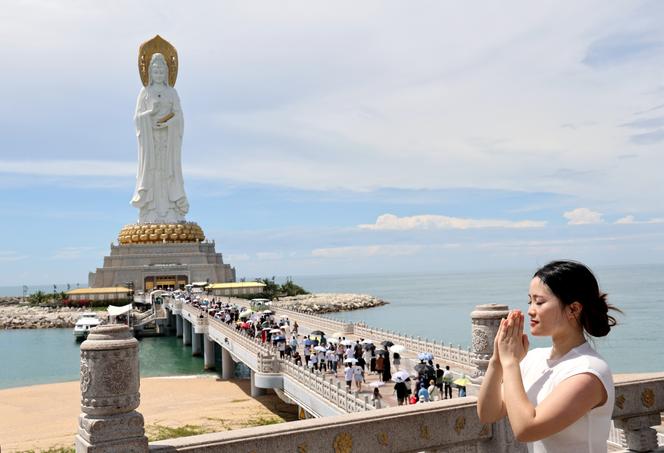 Tourists visit the statue of the goddess Guanyin, in the city of Sanya, Hainan province, China, August 21, 2023.