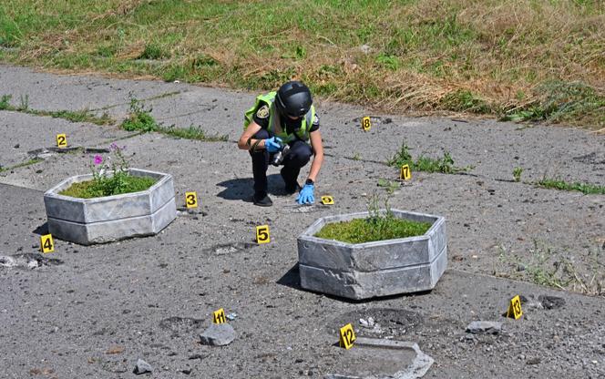 A Ukrainian bomb disposal expert at the site of a fatal cluster bomb attack in Kharkiv, August 8, 2022. 