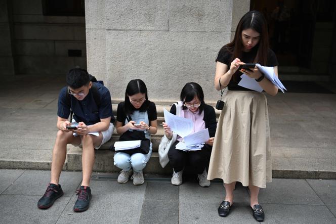 Journalists read the latest ruling on same-sex marriage decided by the Court of Final Appeal in Hong Kong on September 5, 2023.