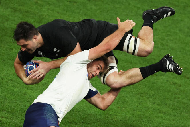 Frenchman Damien Penaud faces New Zealander Luc Jacobson, during the opening match of the Rugby World Cup, at the Stade de France, in Saint-Denis, on September 8, 2023.