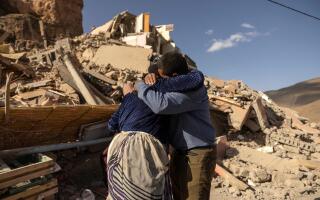 Family members react near the rubble of collapsed buildings in the village of Imi N'Tala near Amizmiz in central Morocco after the deadly 6.8-magnitude September 8 earthquake, on September 10, 2023. Using heavy equipment and even their bare hands, rescuers in Morocco on September 10 stepped up efforts to find survivors of a devastating earthquake that killed more than 2,100 people and flattened villages. (Photo by FADEL SENNA / AFP)