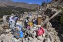 TOPSHOT - Residents salvage belongings from the rubble of Imoulas village in the Taroudant province, one of the most devastated in quake-hit Morocco, on September 11, 2023. Moroccan rescuers supported by newly-arrived foreign teams on September 11 faced an intensifying race against time to dig out any survivors from the rubble of mountain villages, on the third day after the country's strongest-ever earthquake. (Photo by Fethi Belaid / AFP)