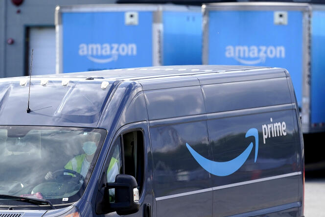Trucks leave an Amazon warehouse in Machusetts, United States, October 1, 2020.