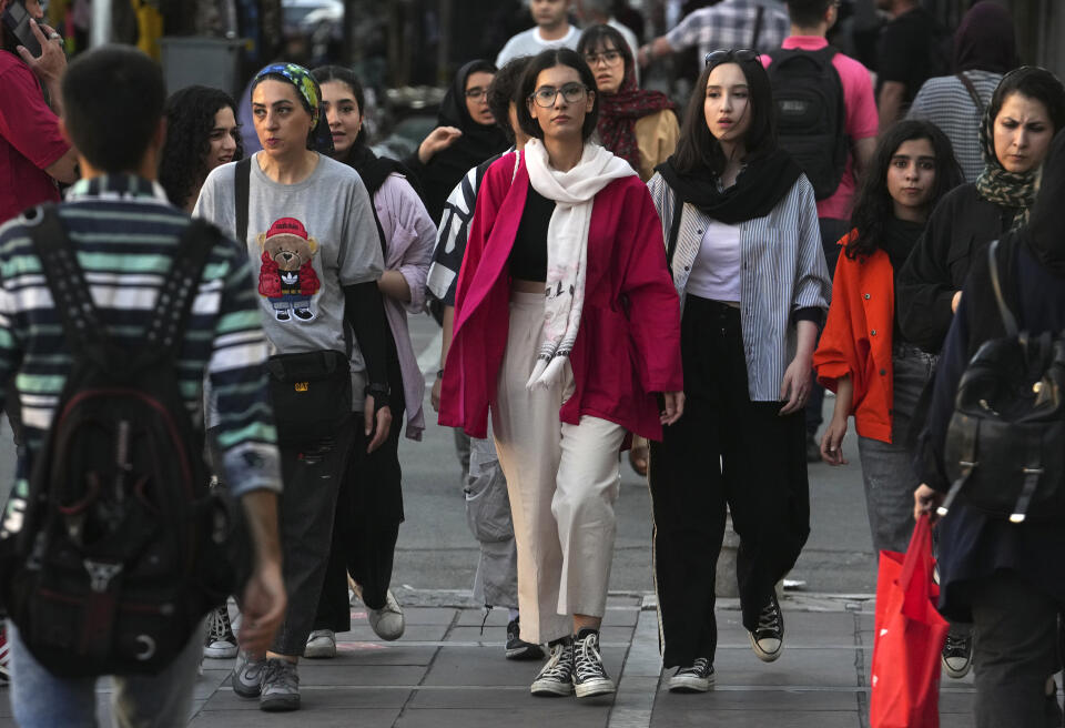 Iranian women, some without wearing their mandatory Islamic headscarves, walk in downtown Tehran, Iran, Saturday, Sept. 9, 2023. Iranians are marking the first anniversary of nationwide protests over the country's mandatory headscarf law that erupted after the death of a young woman detained by morality police. (AP Photo/Vahid Salemi)