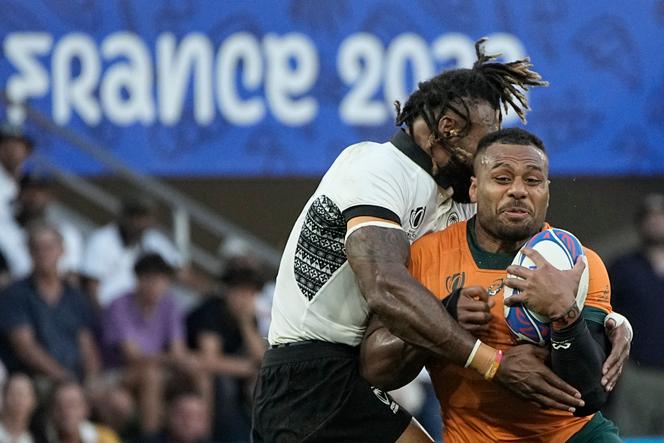 Australia's Samu Kerevi, right, is tackled by Fiji's Waisea Nayacalevu during the Rugby World Cup Pool C match between Australia and Fiji at the Stade Geoffroy Guichard in Saint-Etienne, France, Sunday, September 17, 2023.