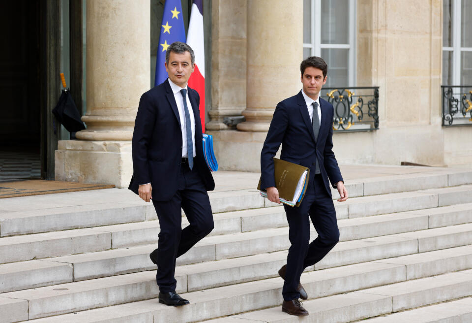 France's Interior Minister Gerald Darmanin and France's Secretary of State and Government's spokesperson Gabriel Attal leave the weekly cabinet meeting at The Elysee Presidential Palace in Paris on March 16, 2022. (Photo by Ludovic MARIN / AFP)