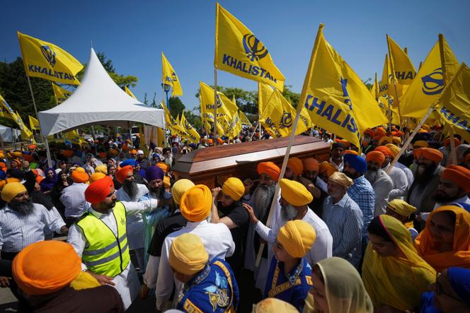 Mourners carry the casket of Sikh community leader and temple president Hardeep Singh Nijjar during Antim Darshan, the first part of a day-long funeral service for him, in Surrey, British Columbia, on June 25, 2023. 