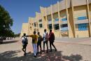 Students walk outside the University Thomas Sankara near Ouagadougou in Burkina Faso on October 15, 2021 during the inauguration of the bust of Thomas Sankara. (Photo by Issouf SANOGO / AFP)