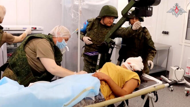 In a screenshot of a video posted on September 20, 2023, an injured civilian is helped by Russian peacekeepers following the start of a military operation by Azerbaijani forces in the Nagorno-Karabakh region.